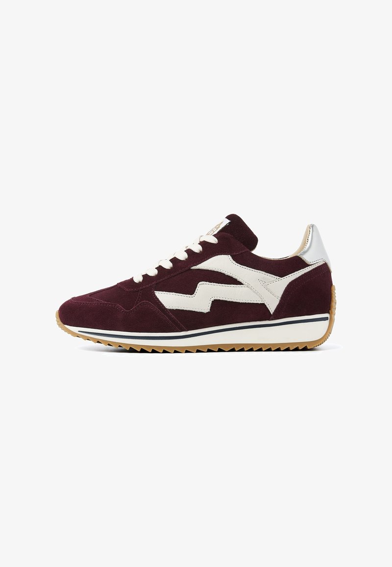 Maroon suede sneaker with white zigzag side panel, white laces, silver heel tab, and gum sole with serrated bottom.
