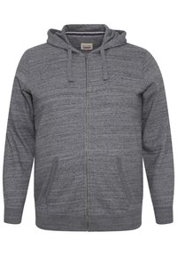 Sudadera con cremallera gris de tejido texturizado, que cuenta con capucha ajustable y bolsillos laterales, diseñada para la comodidad y el uso diario.
