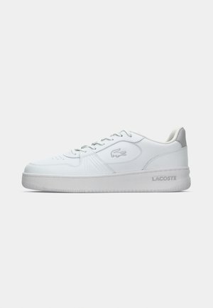White leather sneaker with a sturdy design, featuring a round toe, lace-up closure, textured rubber sole, and subtle Lacoste logo detail.