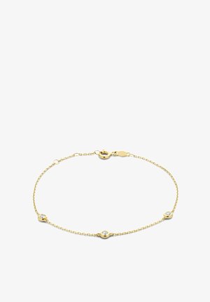 Bracelet délicat en chaîne d’or avec trois pierres claires rondes serties clos uniformément espacées et une fermeture à anneau ressort.