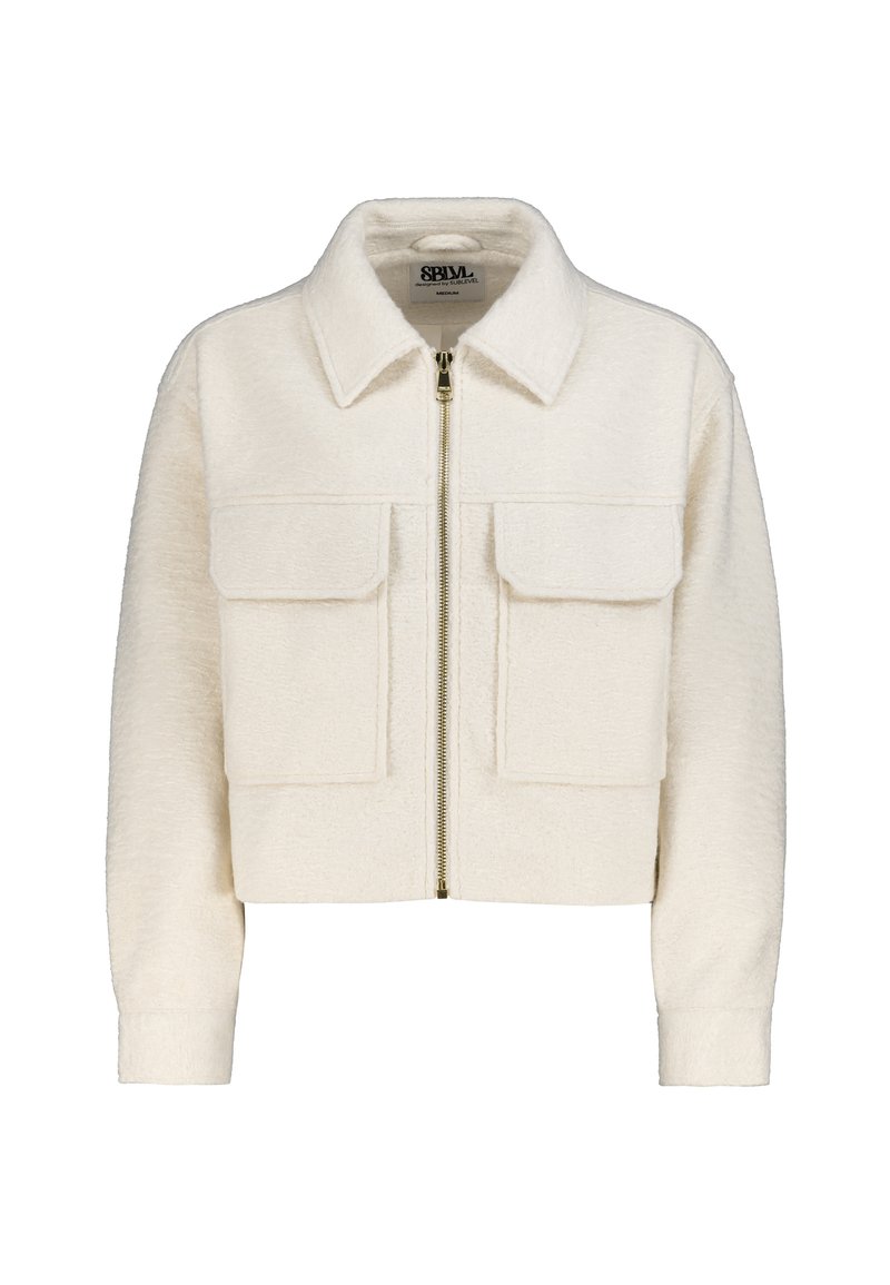 Cropped white jacket in textured fabric with a spread collar, front zipper, and two chest pockets. Features ribbed cuffs.