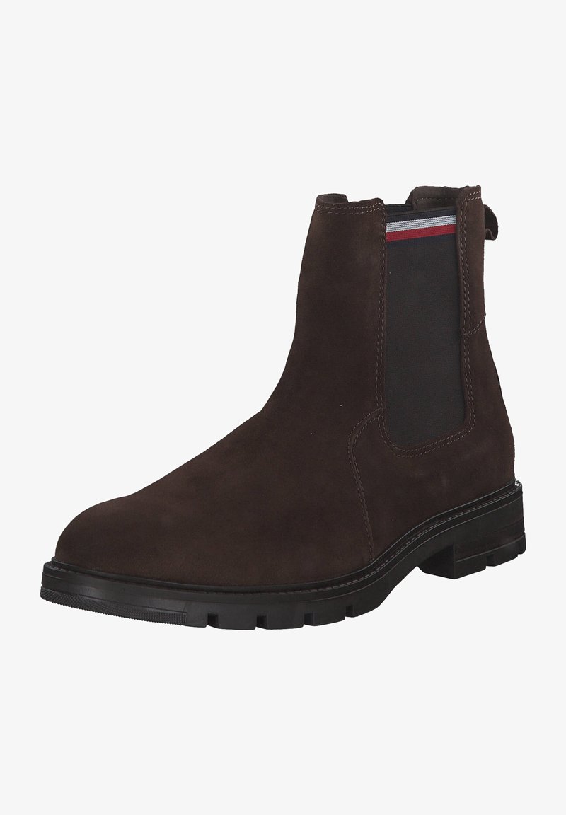 Bottine Chelsea en daim marron avec panneau latéral élastique noir orné de rayures rouges et blanches, semelle crantée noire et languette de tirage à l'arrière.