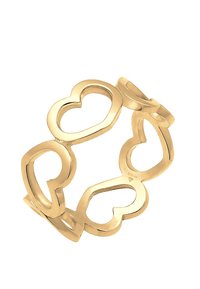 Gold-tone ring featuring linked heart shapes with a polished finish, creating a smooth texture and open design.