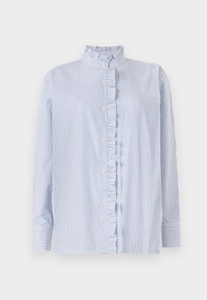 Svītrains krekls zilā un baltā krāsā, ar volānveida apkakli, garām piedurknēm un pogu aizdari. Izgatavots no viegla auduma.