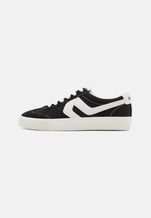 Black canvas sneakers with white accents, featuring a textured rubber sole, rounded toe, and classic lace-up design.