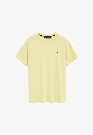 T-shirt a maniche corte di colore giallo chiaro con scollatura rotonda e un piccolo logo scuro di un giocatore di polo sul lato sinistro del petto.