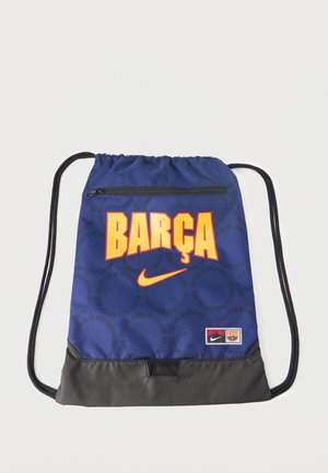 Sac à cordon bleu avec "BARÇA" en grandes lettres jaunes, logo Nike, écusson du FC Barcelone, poche zippée à l'avant et panneau inférieur noir.