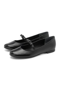 Bailarinas de charol negro estilo Mary Jane con punteras redondas y tiras finas que presentan pequeños lazos, exhibidas una al lado de la otra sobre un fondo blanco.