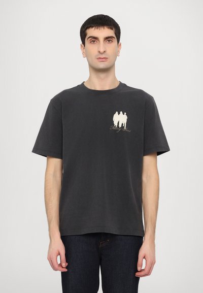 Black cotton t-shirt with a crew neckline, featuring a white graphic of three figures on the left chest. Short sleeves and relaxed fit.