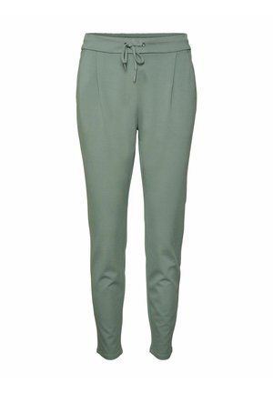 Roheline jooksupüksid, millel on paelavöö, kaks esikotti, sile tekstuur ja kitsenevad jalad. Materjal tundub pehme ja veniv.