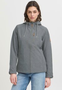 Pilkas zip-up džemperis su gobtuvu, su raištelių akcentais, tekstūruota medžiaga ir odinė aplikacija ant rankovės. Atsitiktinis kirpimas ir lengvas dizainas.
