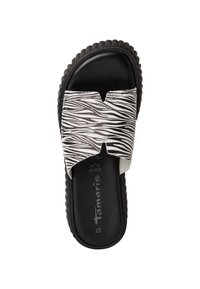 Črne in bele natikače z zasnovo zebra prug, odprtimi prsti, teksturirano gumijasto podplati in blagovno znamko na vložku.