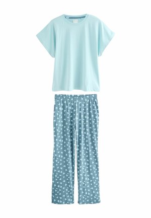 Light blue short-sleeve cotton t-shirt paired with patterned blue pajama pants featuring small white hearts. Soft, relaxed fit, elastic waistband.