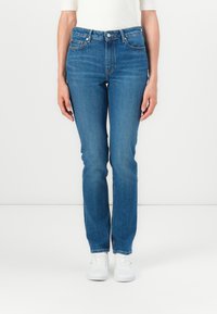 Blue high-waisted jeans with a straight leg design, featuring five pockets, belt loops, and subtle stitching along the seams.