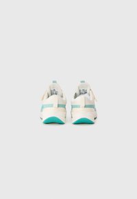 Une paire de chaussures de sport blanches et turquoise vues de l'arrière sur un fond blanc uni.