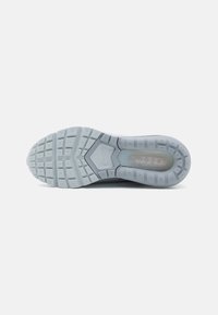 Light blue athletic shoe outsole featuring a textured surface, rectangular lugs for traction, and a visible air cushioning unit.
