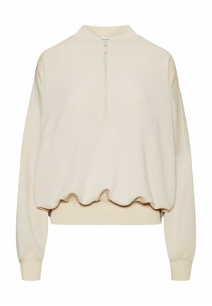 Beżowa krótka bluza z długimi rękawami, półzamkiem z przodu, elastycznym dołem i prążkowanymi mankietami.