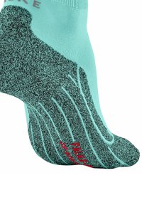 Zbliżenie na turkusową skarpetę z ciemnoszarymi wzorami teksturowymi i czerwoną marką, ukazujące kształt skarpety oraz detale dzianiny.