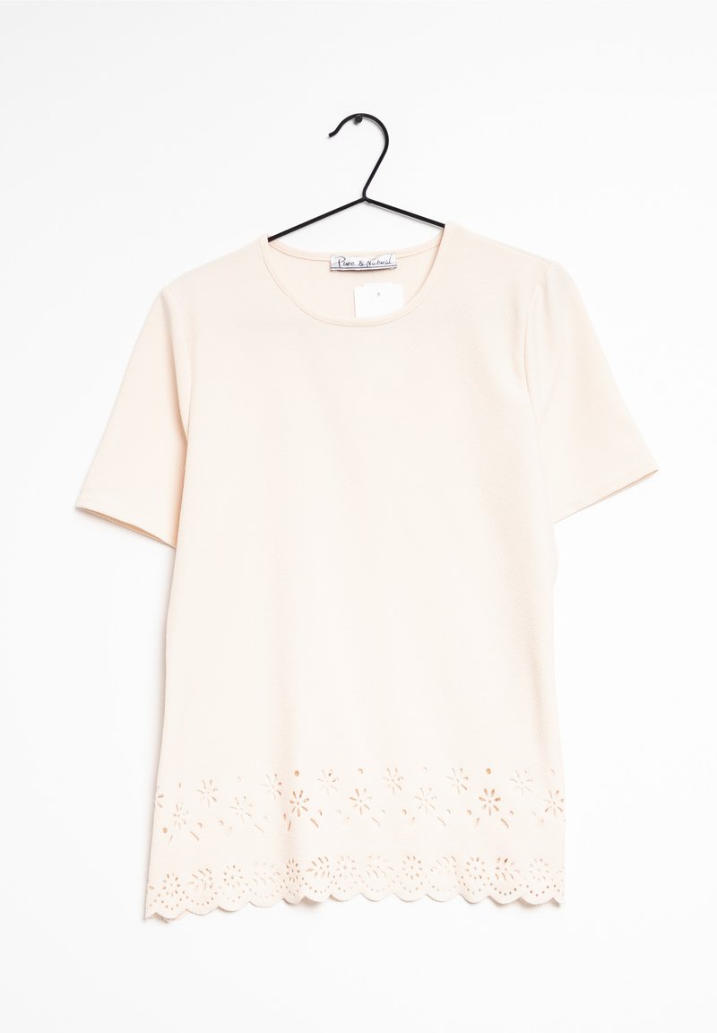 Top leggero rosa chiaro a maniche corte con scollatura rotonda e motivo floreale a intaglio all'orlo. Tessuto morbido con una sottile trama.