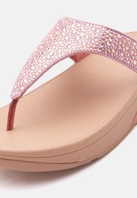 Ροζ πλατφόρμα σαγιονάρα με υφή στη σόλα και λουρί στολισμένο με λαμπερά στρας.