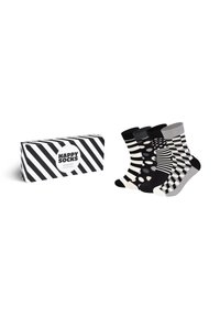 Cadeau en boîte rayée noir et blanc contenant trois paires de chaussettes en coton : à pois, rayées et à motif géométrique. Chacune présente des couleurs contrastées.