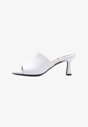 White open-toe mule with mid-height curved heel and slip-on design, featuring smooth upper and black sole edges.