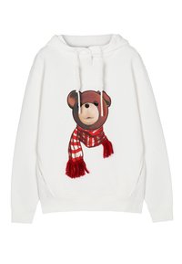 Biela mikina s potlačou medveďa v červeno-bielom pruhovanom šále s strapcami. Jemný materiál a voľný strih.