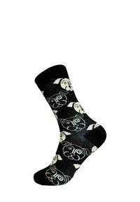 Svarta strumpor med ett upprepande mönster av vita tecknade hundansikten, tillverkade av ett mjukt och stretchigt material. Standard längd för crew-strumpor.
