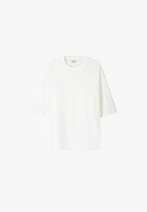 Vit t-shirt med kort ärm av bomull, med rund halsringning och en avslappnad passform med rak fåll.