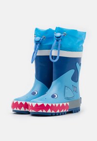 Blauwe rubberen regenlaarzen met een haai ontwerp, met een lichtere blauwe bovenkant, een witte streep en een rode tandenpatroon op de zolen.