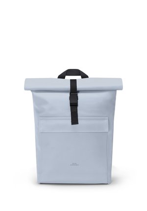 Light gray roll-top backpack with front pocket and black buckle strap, standing upright on a white background.