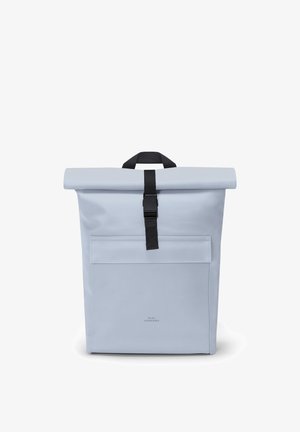 Light gray roll-top backpack with front pocket and black buckle strap, standing upright on a white background.