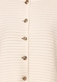 Textured cream-colored knit cardigan with ribbed pattern, featuring six large gold-tone buttons along the front.