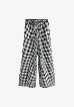 Czarno-białe spodnie w kratkę o szerokich nogawkach z elastycznym pasem, sznurkiem i dwiema bocznymi kieszeniami. Lekki materiał, luźny krój.