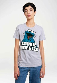 Gray cotton t-shirt featuring a blue Cookie Monster graphic holding a cookie, with bold text reading "Cookie Monster" in white and black.