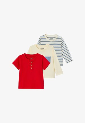 Three children's shirts: a red short-sleeve with buttons, a cream long-sleeve with a blue pocket, and a cream-blue striped long-sleeve.