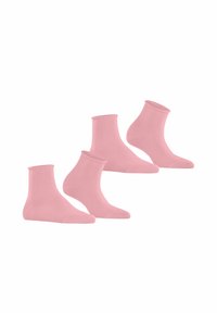 Chaussettes en coton rose à col côtelé, avec une texture lisse et un design ajusté. Quatre paires exposées ensemble.