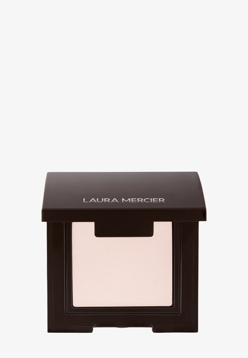 Laura Mercier compacte poeder in zwarte behuizing met een doorzichtig venster, met daarin een lichtbeige poeder.