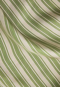 Cotton fabric features thin, vertical green stripes on a cream background, showcasing a smooth texture and a subtle sheen.