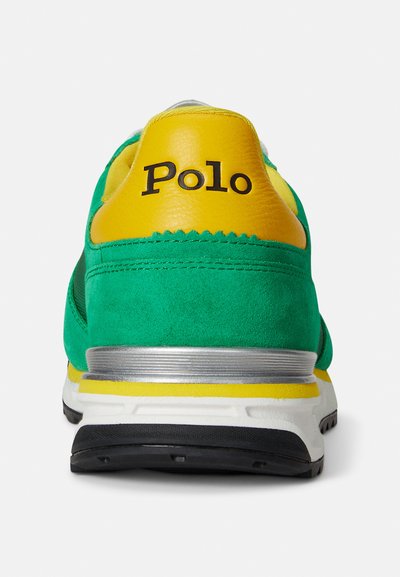 Green and yellow sneaker with a suede upper, a cushioned heel, black rubber sole, and "Polo" branding in black on the heel cap.