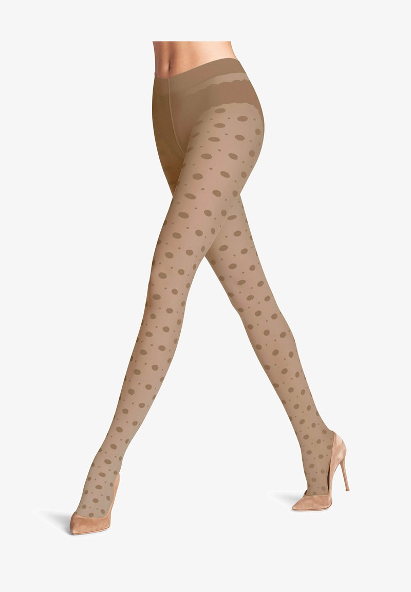 Collant a pois nudi con finitura trasparente, caratterizzati da motivi circolari color carne e una texture liscia, abbinati a tacchi alti beige.