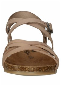 Nude leather sandal with crisscross strap design, textured cork footbed, and a slight heel. Features a metal buckle and smooth underside.