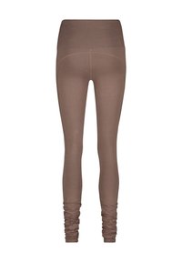 Leggings marron avec une taille haute et des poignets froncés. Fabriqués en tissu lisse et extensible. Présentent des coutures de contour le long du dos.