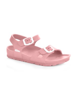 Różowe sandały wykonane z gładkiego kauczuku, z dwiema regulowanymi klamrami w kolorze białym, otwartym noskiem oraz teksturowaną podeszwą dla lepszej przyczepności.