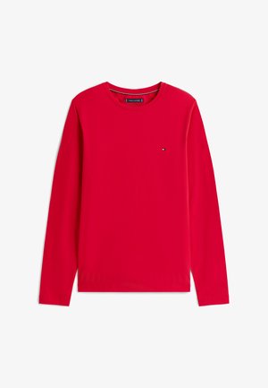 Punane pikakätised särk, mis on valmistatud puuvillast. Omab ümarat kaelaauku ja väikest logosümbolit vasakul rinnakorvil. Sile tekstuur ning ühtlane värv.