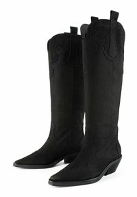 Bocanci de cowboy din suede negru, cu vârfuri ascuțite, cusături ridicate într-un model ondulat și un toc scăzut, stratificat. Include mânere pentru o îmbrăcare ușoară.