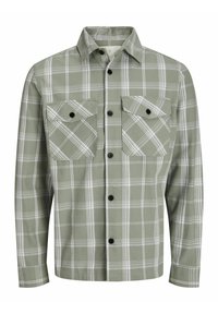 Groene geruite shirt gemaakt van zachte stof, met een knoopsluiting aan de voorkant, twee borstzakken en zwarte knopen. Geaccentueerd met witte lijnen.