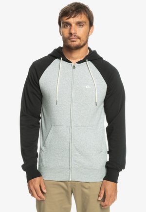 Gray and black zip-up hoodie with a kangaroo pocket, contrasting raglan sleeves, drawstring hood, and small logo on the chest.