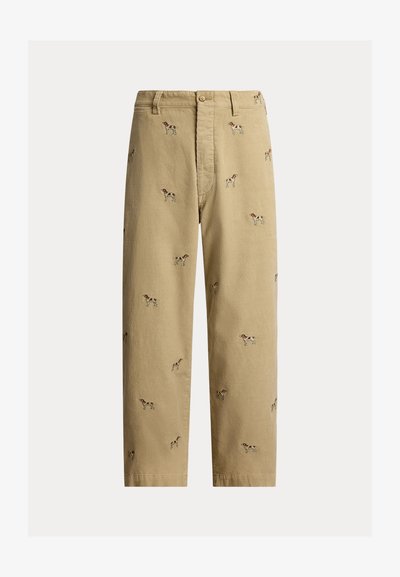 Pantaloni beige in velluto a coste con ricami di cani, taglio a gamba dritta, cinque tasche e chiusura frontale con bottone.