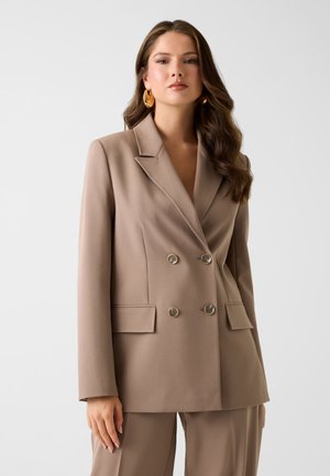 Blazer doppiopetto beige in tessuto liscio, con rever a incavo, due tasche frontali e bottoni color oro.